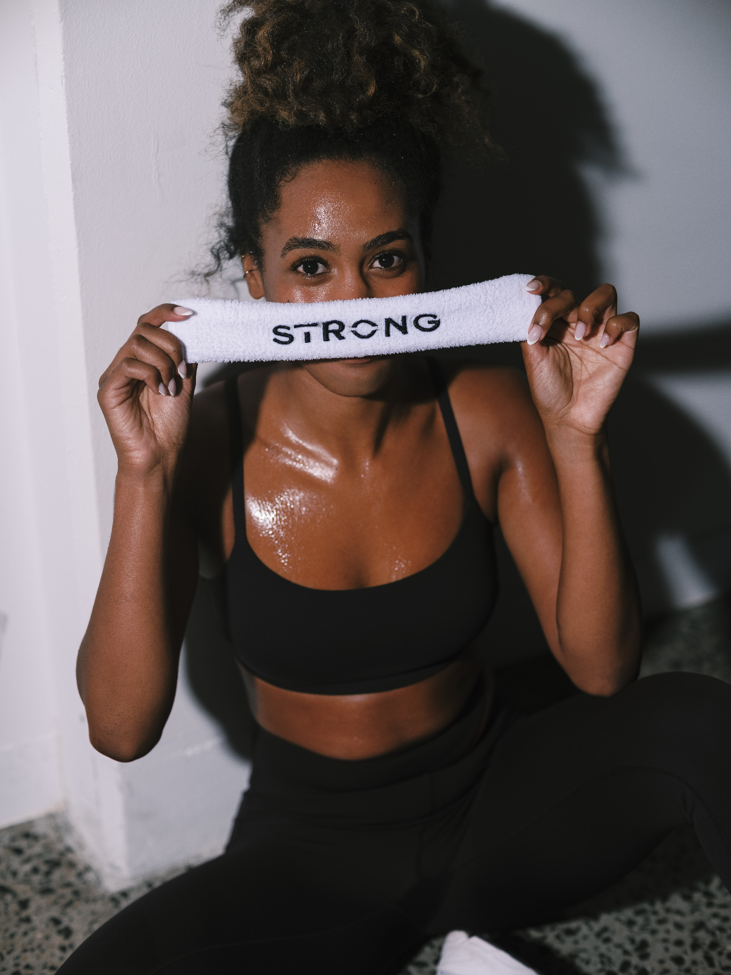 A STRONG member holding a STRONG towel after class